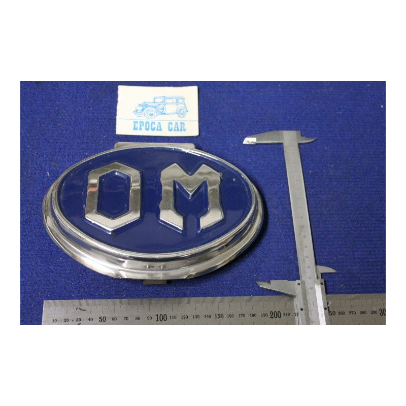 BADGE "OM" LENGHT 195 mm  METAL CHROME IN BLAU BACKGROUND